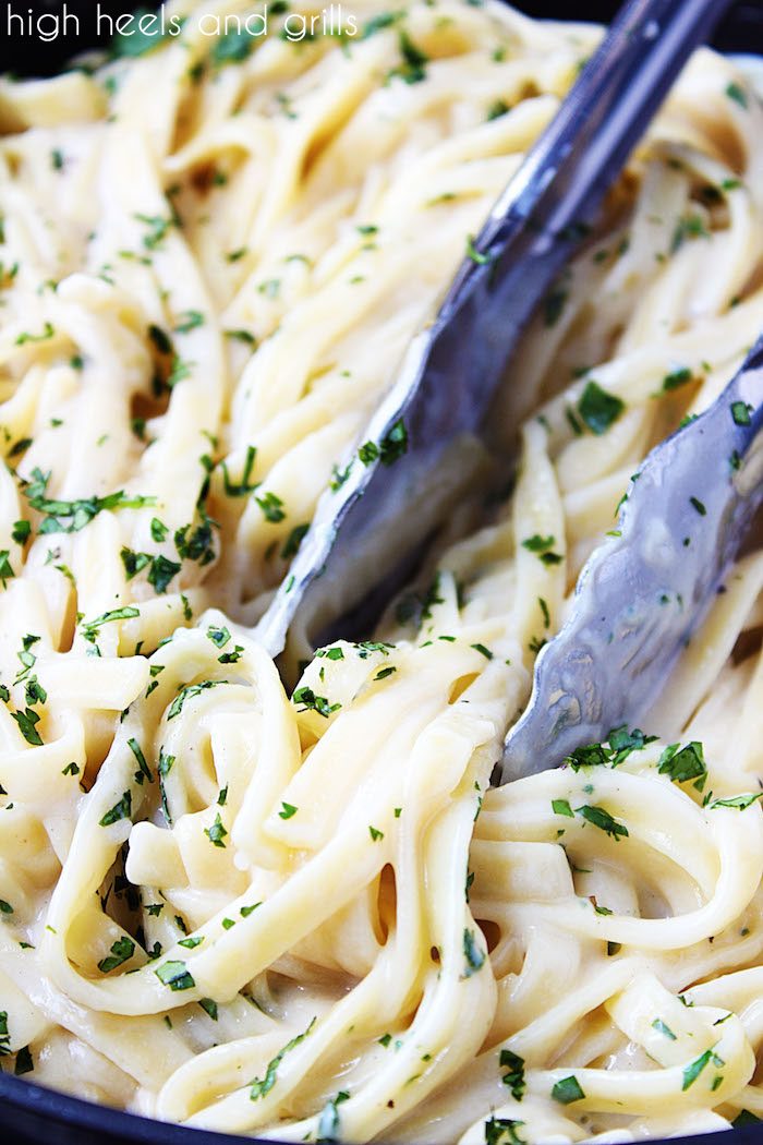 Skinny Alfredo Sauce - Tongs in skillet of noodles