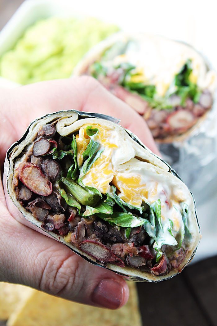 Close up shot of Chipotle Bean Burritos, in hand. High Heels and Grills