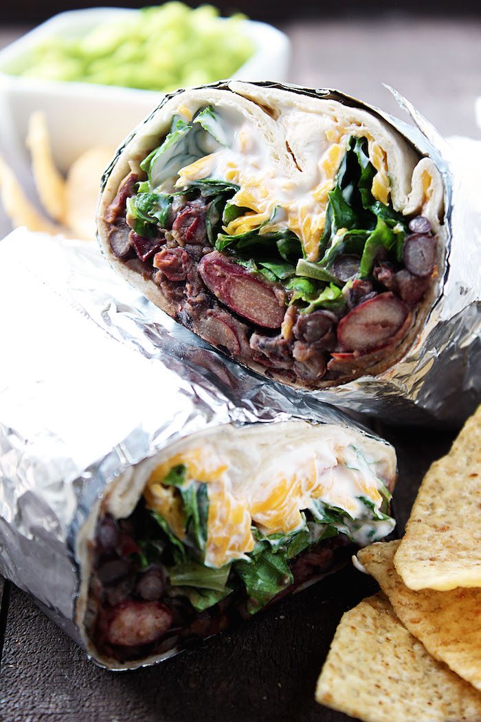 Chipotle Bean Burritos cut in half and wrapped in foil. Chips and guacamole on side. High Heels and Grills