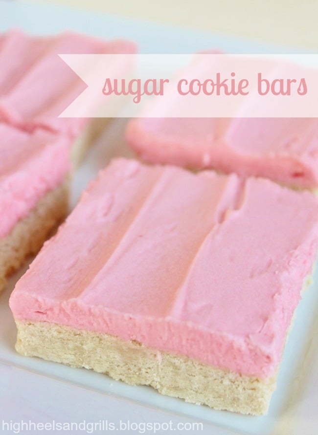 Up close photo of a plate of sugar cookie bars with pink frosting.