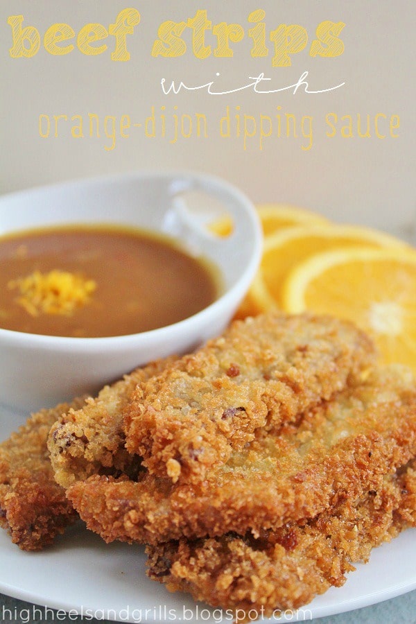 Stack of Beef Strips with a bowl of Orange Dijon Dipping sauce and orange slices in the background.