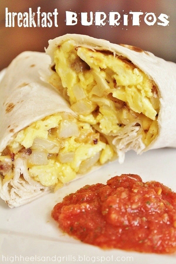 Breakfast burrito cut in half on a plate with salsa.