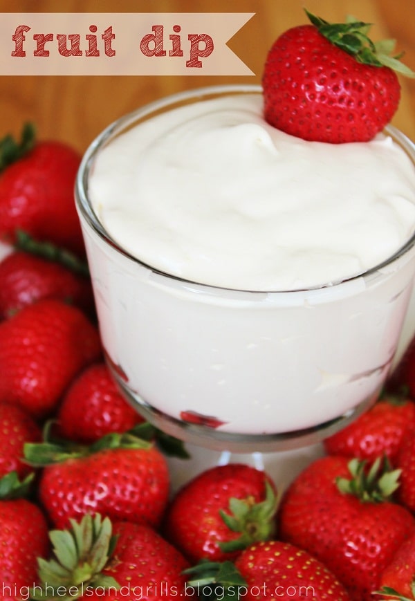 Bowl of Fruit Dip surrounded by whole strawberries.