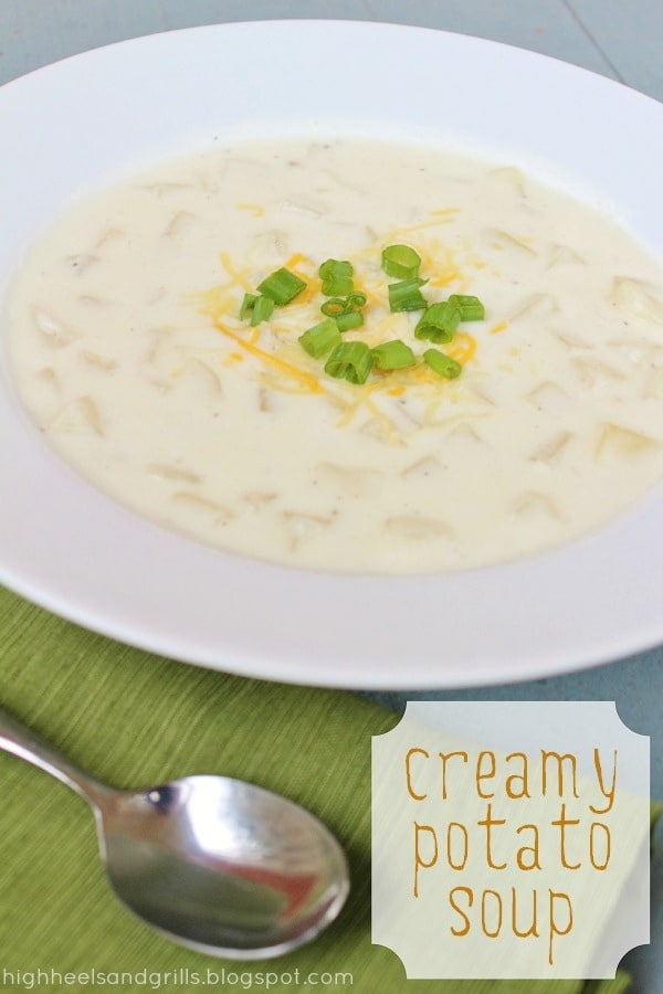 Bowl of Creamy Potato Soup in a bowl, topped with green onions and cheddar cheese.