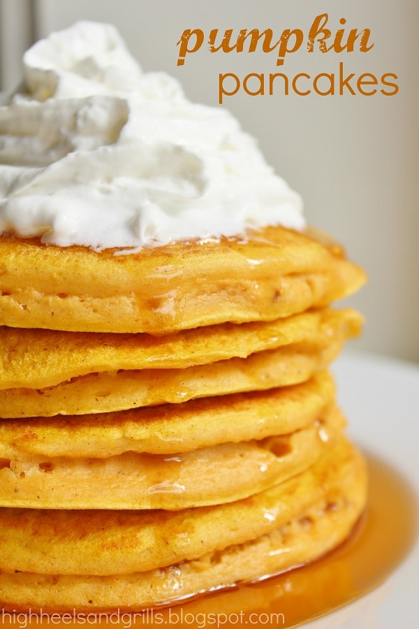 Stack of Pumpkin Pancakes with whipped cream on top.