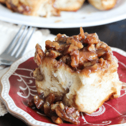 Creamy caramel pecan cinnamon roll on a plate
