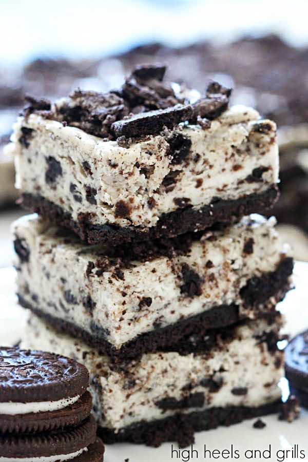 Oreo Cheesecake Bars - stack of three bars with Oreo cookies on the side.