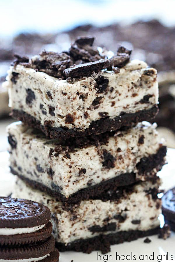 Oreo Cheesecake Bars - stack of three bars with Oreo cookies on the side.