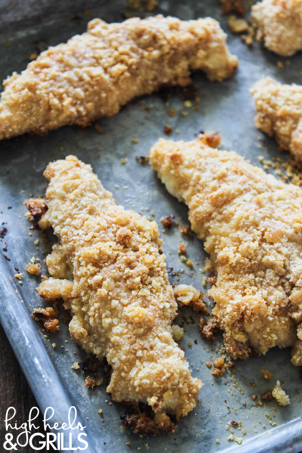 Baked Ritz Garlic Parmesan Chicken Strips - Dipped in yogurt, smothered in Ritz cracker crumbs mixed with garlic salt and parmesan, and drizzled over with butter. Yummy and easy dinner recipe! https://www.highheelsandgrills.com/baked-ritz-garlic-parmesan-chicken-strips-recipe