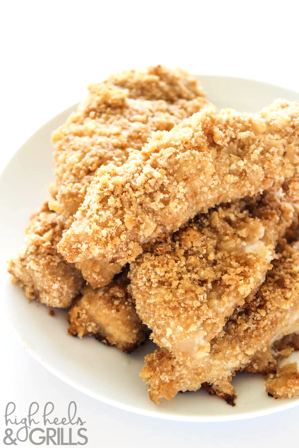 Baked Ritz Garlic Parmesan Chicken Strips - Dipped in yogurt, smothered in Ritz cracker crumbs mixed with garlic salt and parmesan, and drizzled over with butter. Yummy and easy dinner recipe! https://www.highheelsandgrills.com/baked-ritz-garlic-parmesan-chicken-strips-recipe