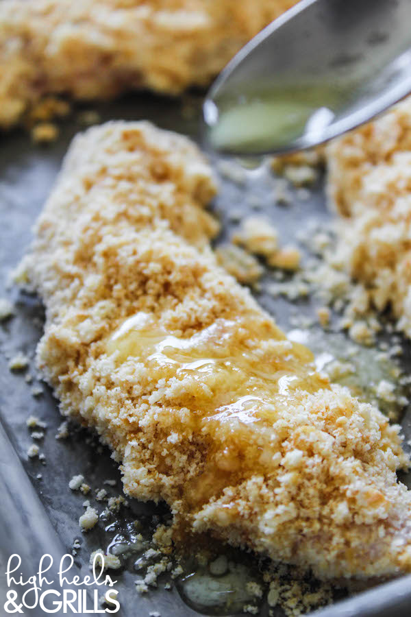 Baked Ritz Garlic Parmesan Chicken Strips - Dipped in yogurt, smothered in Ritz cracker crumbs mixed with garlic salt and parmesan, and drizzled over with butter. Yummy and easy dinner recipe! https://www.highheelsandgrills.com/baked-ritz-garlic-parmesan-chicken-strips-recipe