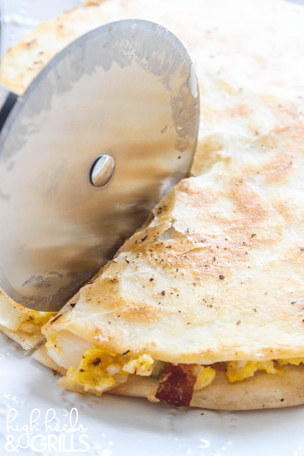 Breakfast Quesadillas - Egg, bacon, peppers, onion, and cheese smothered between two crisp tortillas. Makes for an amazing and quick breakfast!