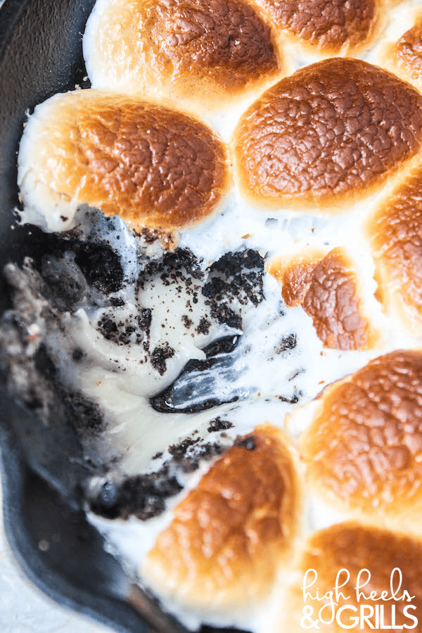 Cookies and Cream Smores Dip - Melted white chocolate chips, crushed Oreos, and toasted marshmallows. Dip with graham crackers to fully enjoy this amazing dessert! https://www.highheelsandgrills.com/cookies-and-cream-smores-dip/
