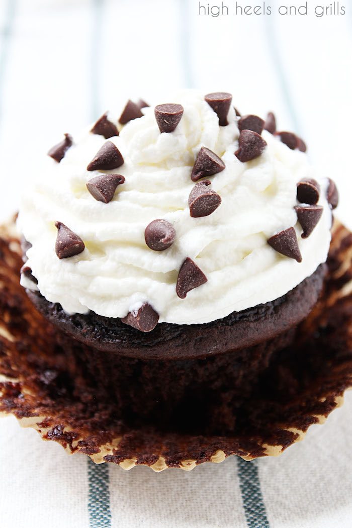 Skinny Chocolate Cupcakes - single cupcake with whipped cream and chocolate chips on top.