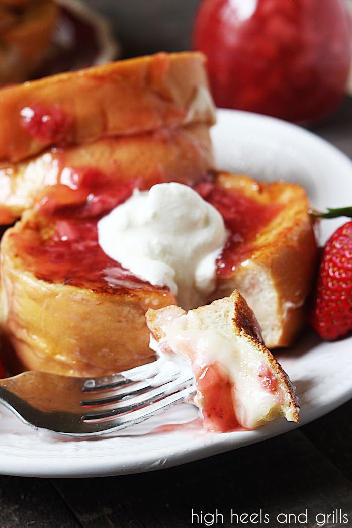 Bite of Strawberry Cheesecake Stuffed French Toast taken out of slice.