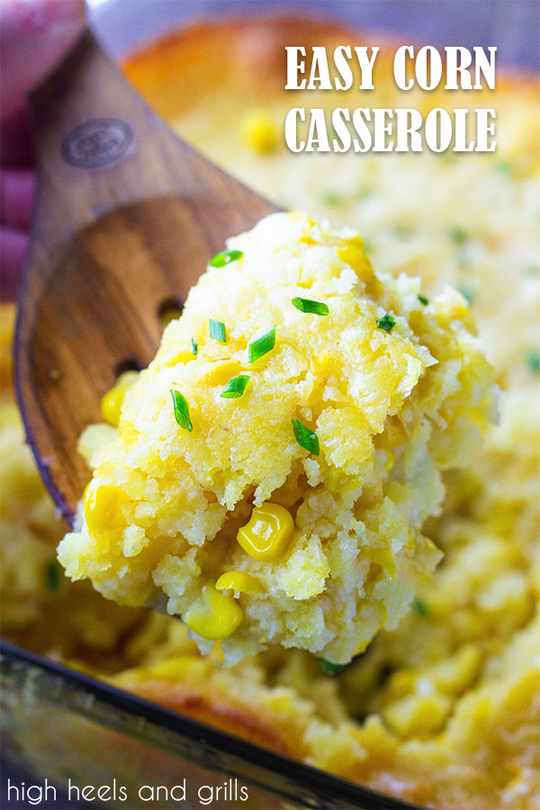 Serving spoon with easy corn casserole on it, with pan of casserole in the background.