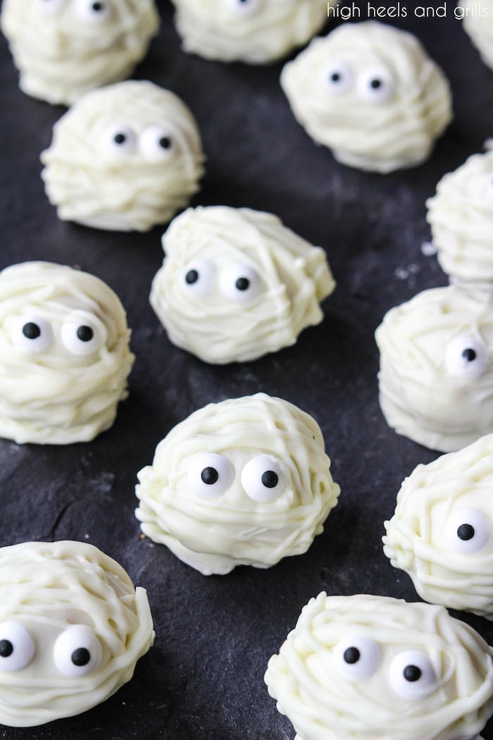 Easy Halloween Treat Donut Hole Mummies spread out on a platter.